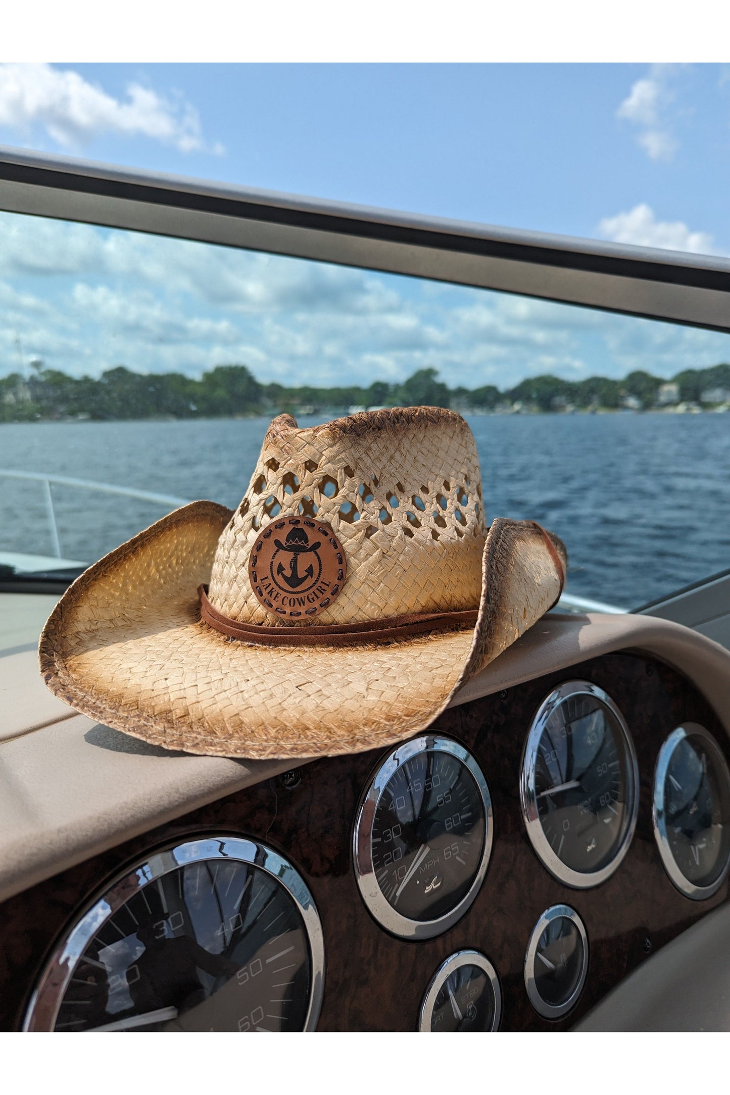 Photo of the Lake Cowgirl Signature Cowboy Hat shown sitting atop a boat console. Photo was taken on Lake Minnetonka.