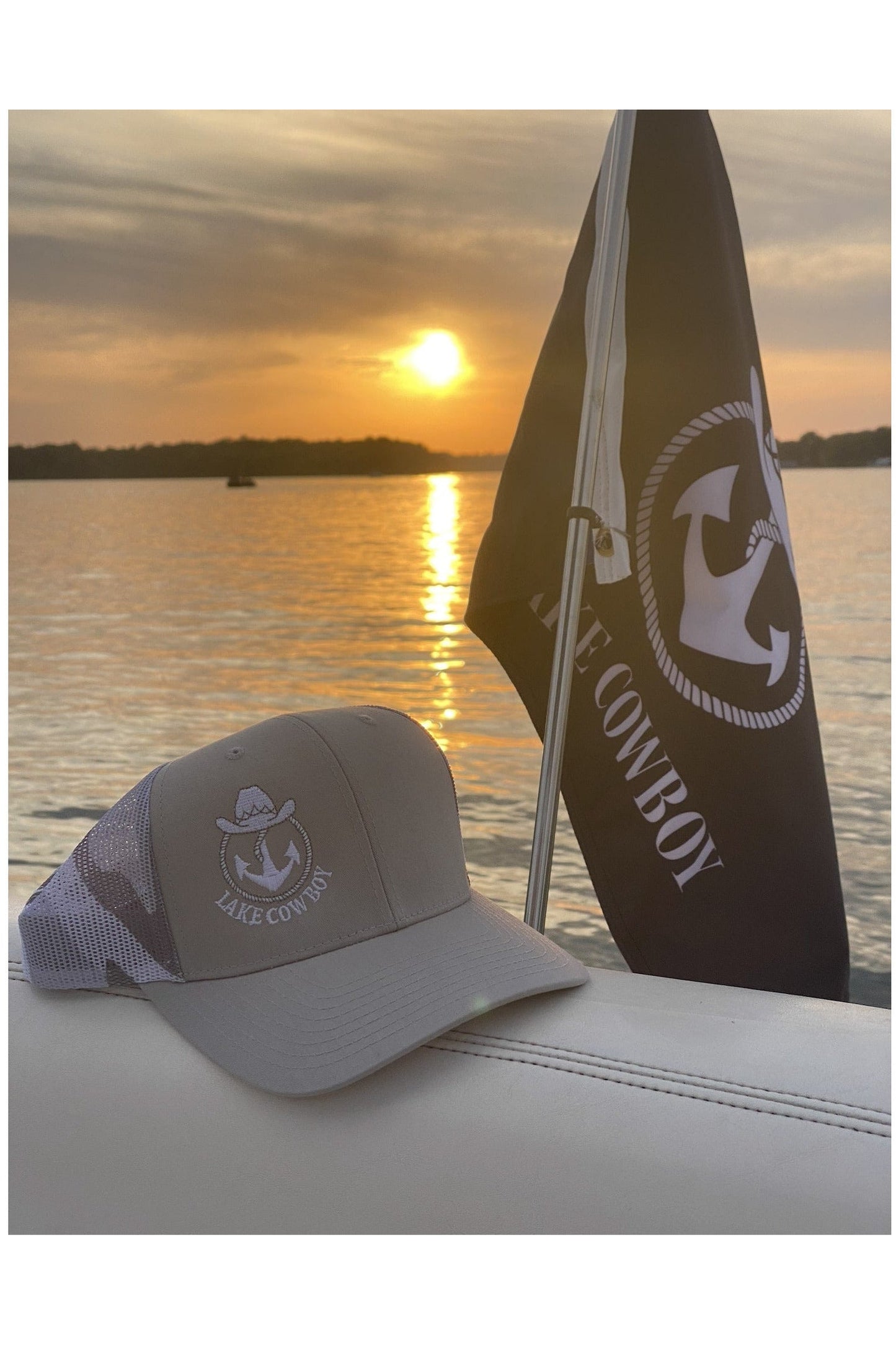 Photo of a Lake Cowboy Baseball Hat (Desert Camo) on the back of a Sea Ray boat at sunset on Lake Minnetonka 