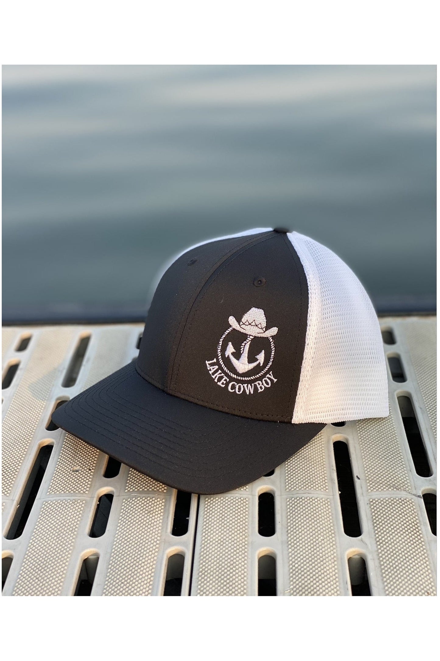 Photo of a Lake Cowboy Baseball Hat (Black & White) on a dock