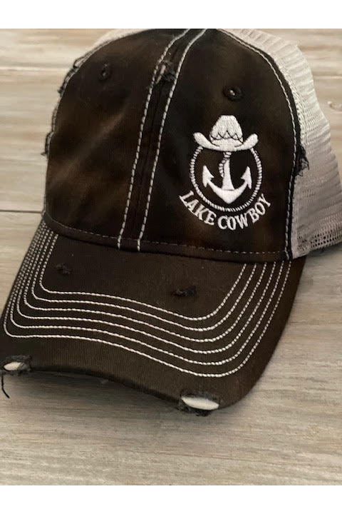 Lake Cowboy Sportsman's Trucker Hat (Black) on a vintage table