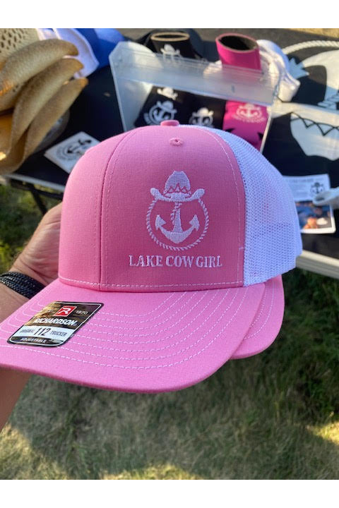 Photo of a Lake Cowgirl Women's Baseball Hat (Pink & White) at We Fest with other Lake Cowboy Products in the background