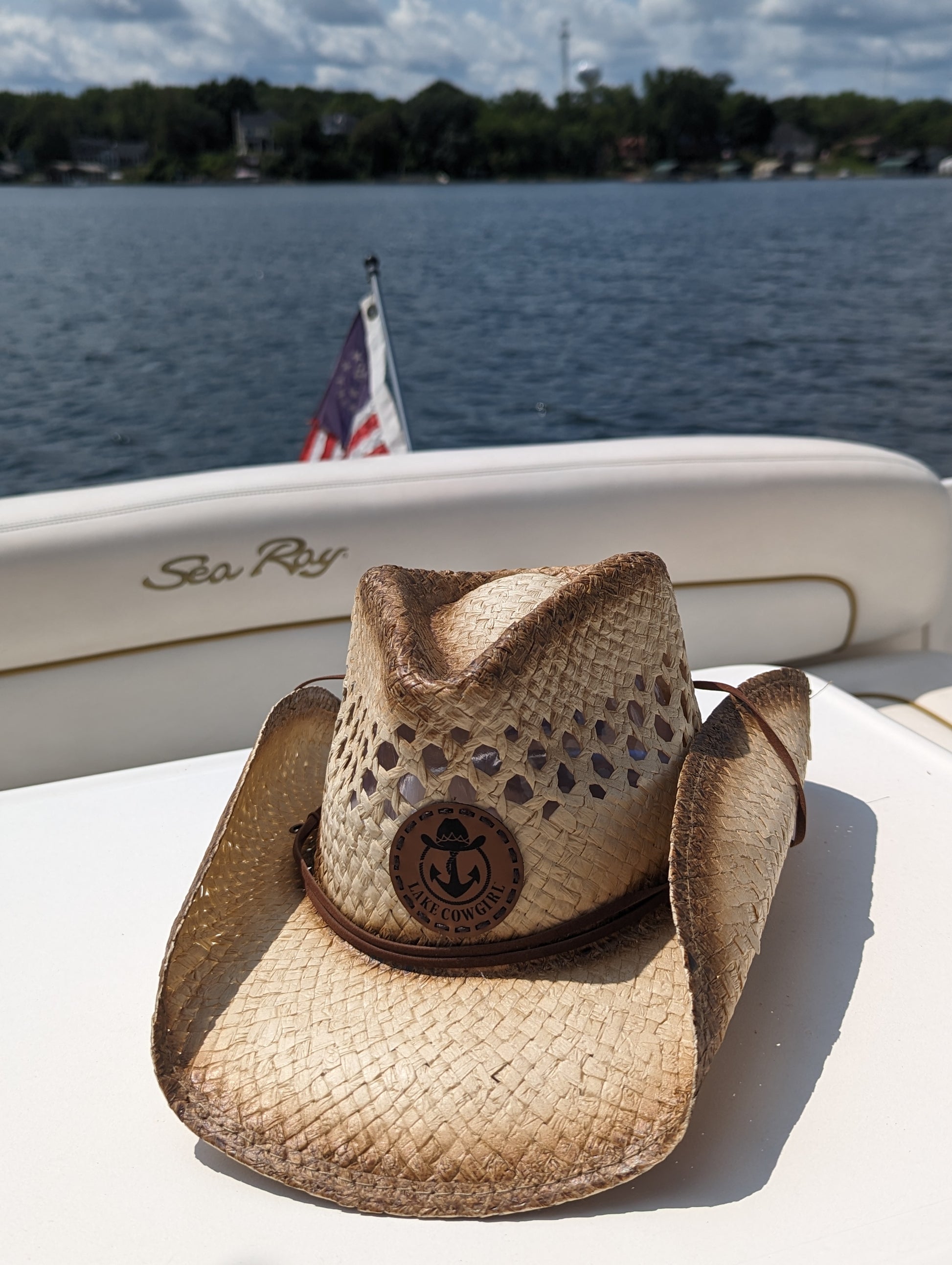 Photo of the Lake Cowgirl Signature Cowboy Hat shown sitting atop a table on a boat. Photo was taken on Lake Minnetonka.