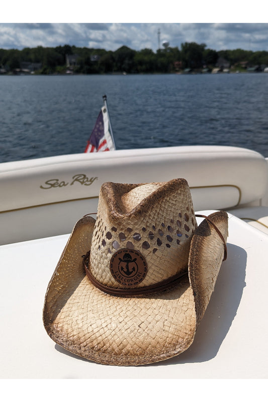 Photo of the Lake Cowgirl Signature Cowboy Hat shown sitting atop a table on a boat. Photo was taken on Lake Minnetonka.