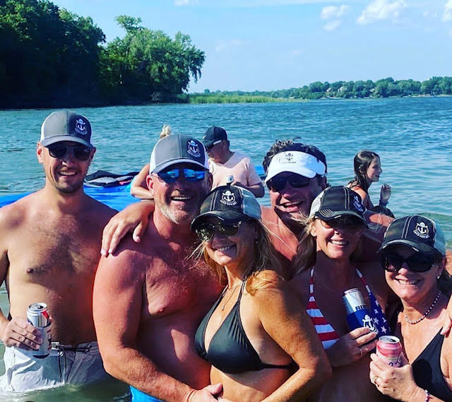 Photo of the Lake Cowboy Crew wearing Lake Cowboy hats and enjoying summer on Lake Minnetonka